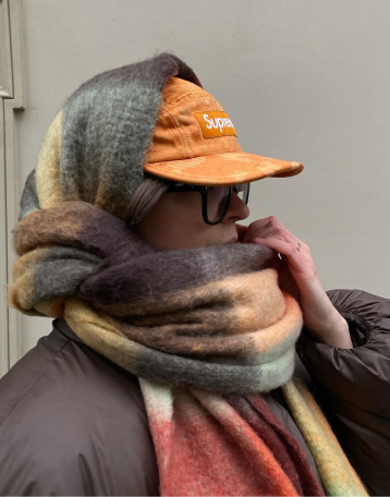 A person wrapped in a striped wool scarf